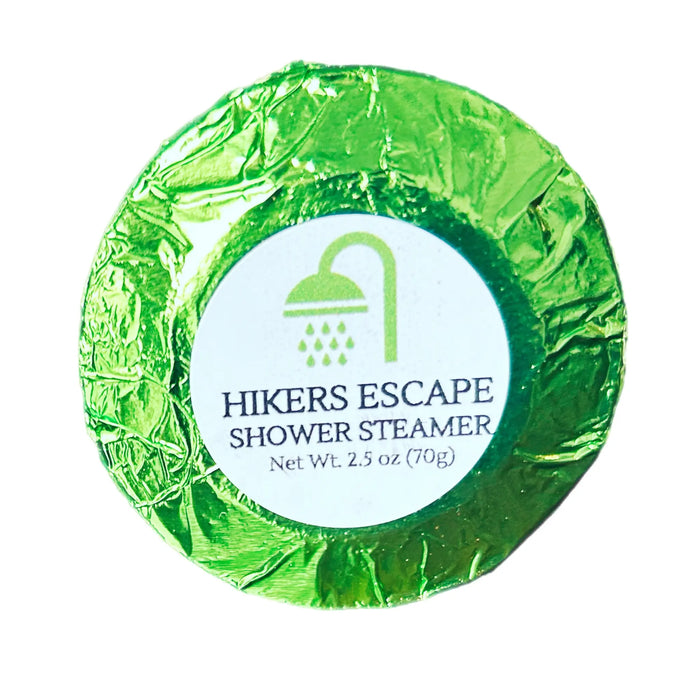 Extra-large 2.5 oz Hiker’s Escape shower steamer, individually wrapped in colored foil, featuring an earthy blend of fresh mountain air, pine, and wild herbs for a refreshing and invigorating shower experience.
